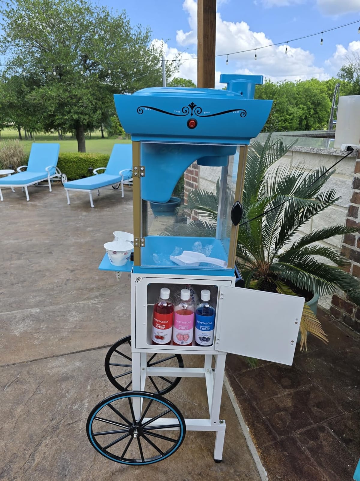 Nostalgia Snow Cone Shaved Ice Machine - Retro Cart Slushie Machine Makes 72 Icy Treats - Includes Metal Scoop, 2 Syrup Bottles, 100 Paper Cups/Spoons, Storage Compartment, Wheels - Blue, 54