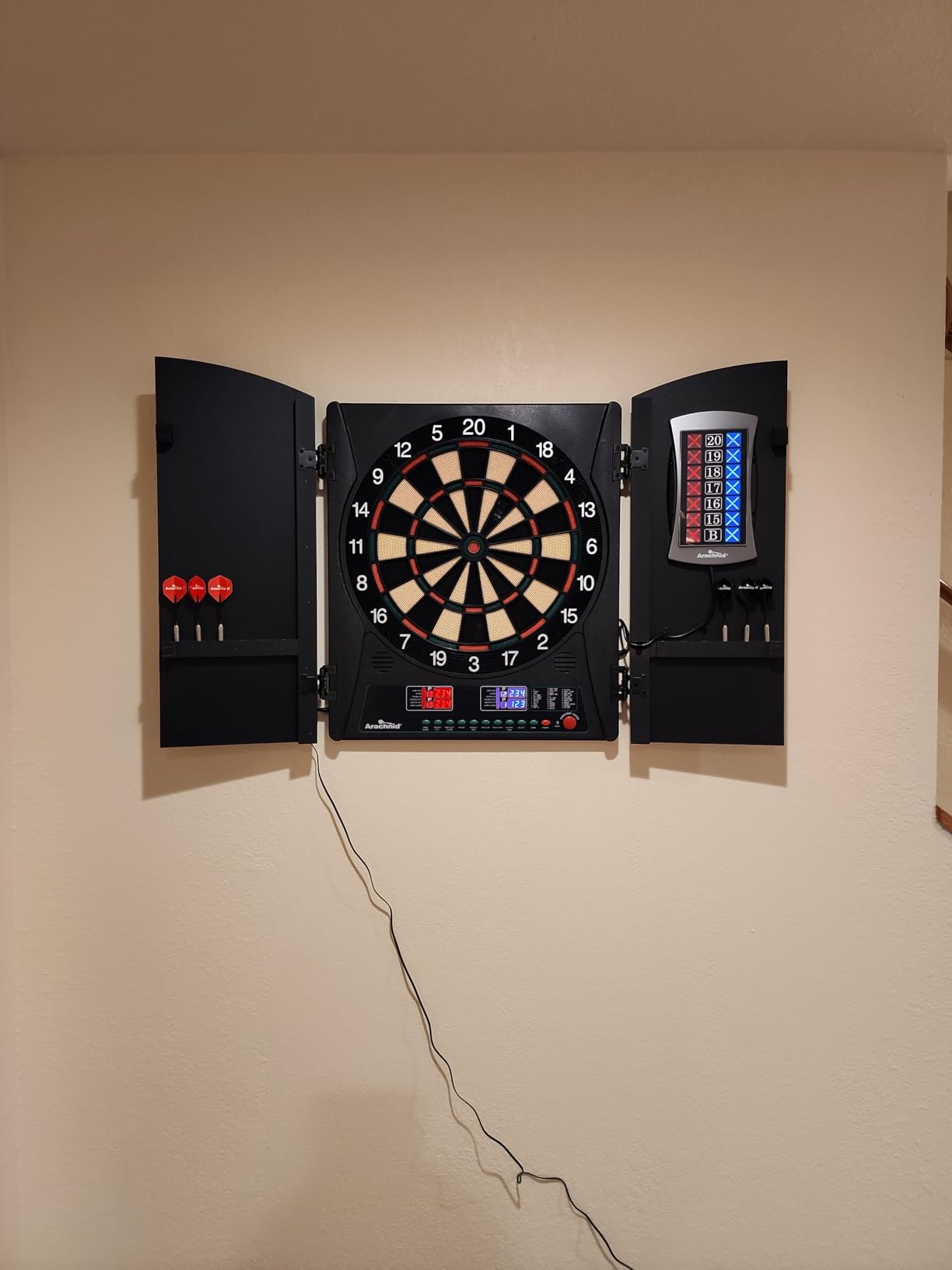 Arachnid CricketMaxx 1.0: 13.5” recreation size with wood cabinet. Features 34 games, 183 variations, 8-player LED X/O scoring, and Heckler mode. Integrated storage for darts and accessories customer photo 1
